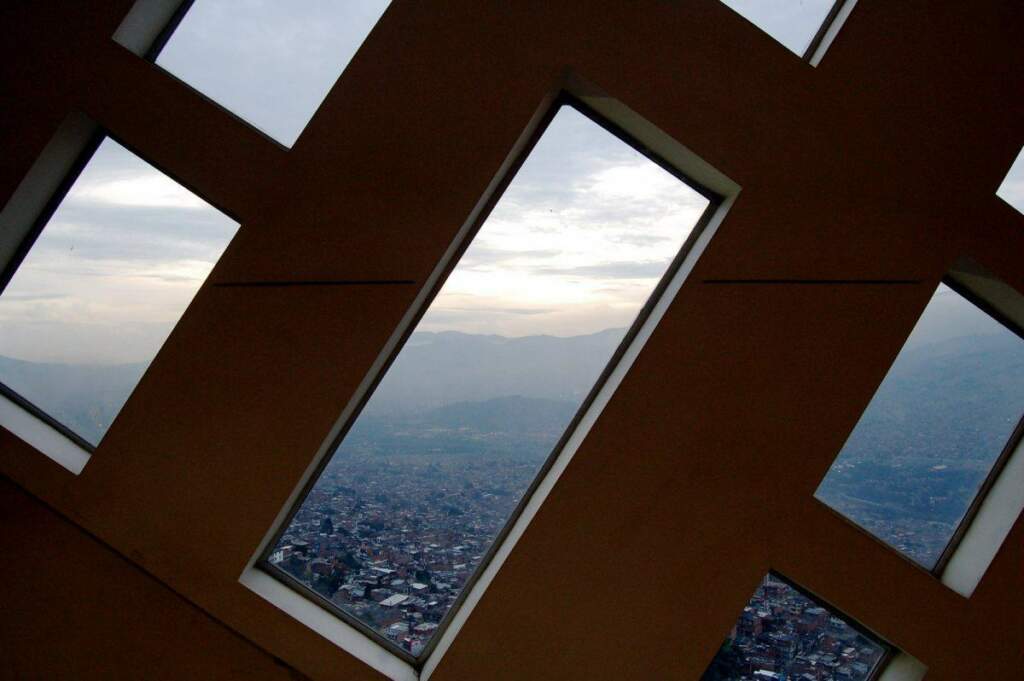 from-inside-the-library-in-the-santo-domingo-savio-neighborhood-the-view-is-of-medelln-itself-in-a-valley-surrounded-by-the-andes