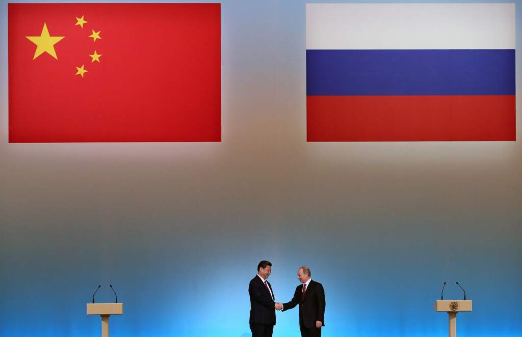 China's President Xi Jinping (L) is welcomed by his Russian counterpart Vladimir Putin (R) during the opening ceremony of "The Year of Chinese Tourism in Russia" in Moscow, on March 22, 2013. China's new president Xi Jinping arrived today in Moscow on his first foreign visit since assuming the presidency earlier this month. Xi Jinping and his counterpart Vladimir Putin are set to oversee the signing of a number of energy and investment agreements including a deal that will see Russia ramp up oil supplies to China. AFP PHOTO / POOL / SERGEI ILNITSKY (Photo credit should read SERGEI ILNITSKY/AFP/Getty Images)